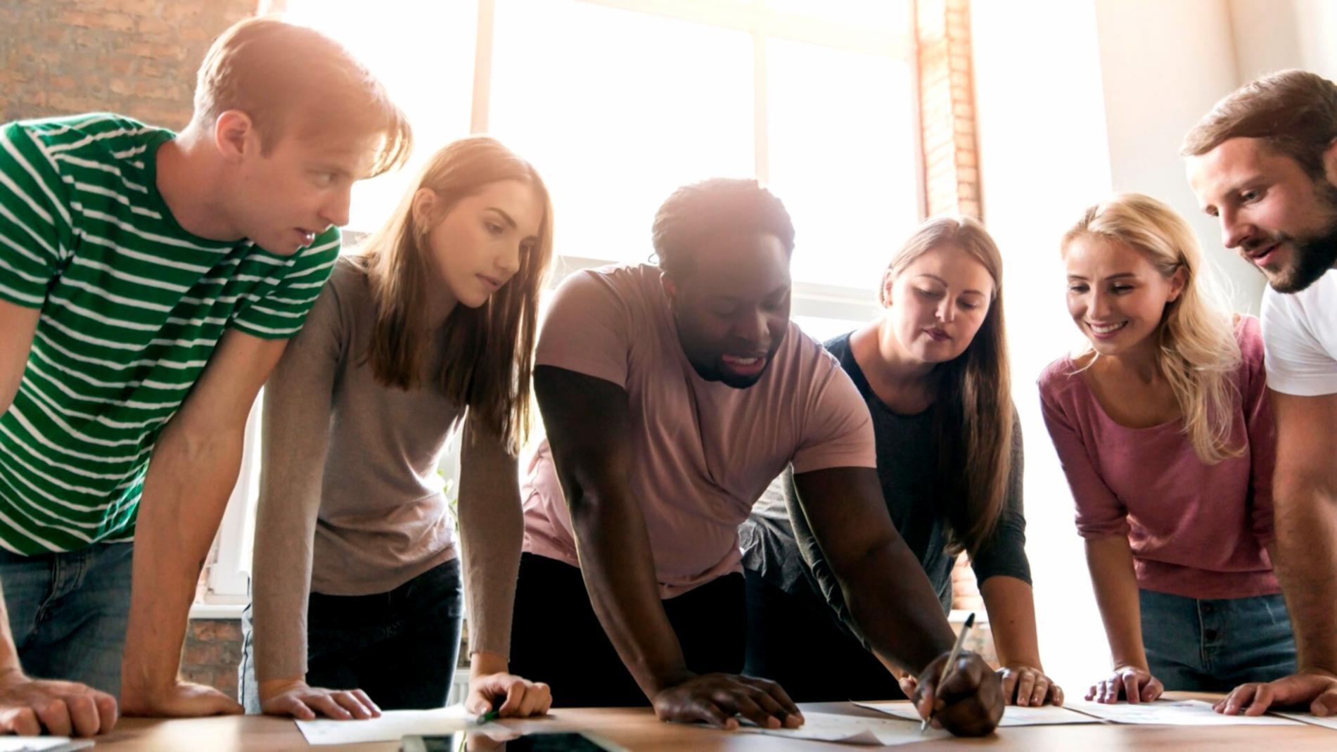 Financial analysts working together on corporate finance strategy in modern Australian office